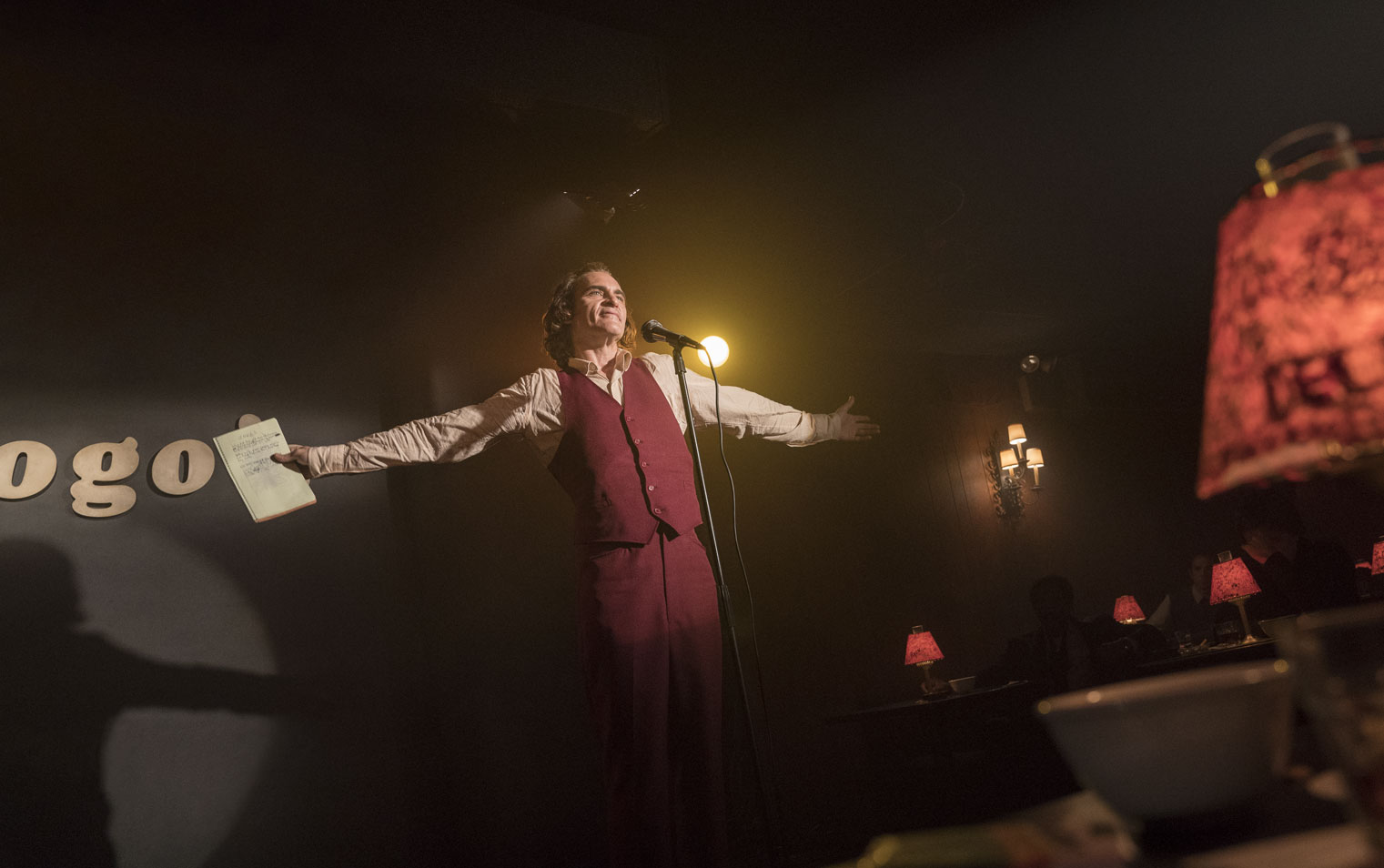 Film still from Joker of Arthur Fleck (Joaquin Phoenix) at comedy club